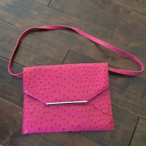 Hot pink oversized clutch or can be worn over shoulder with removable strap